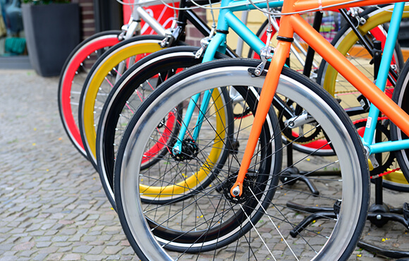 Parked bikes on sidewalk in the city